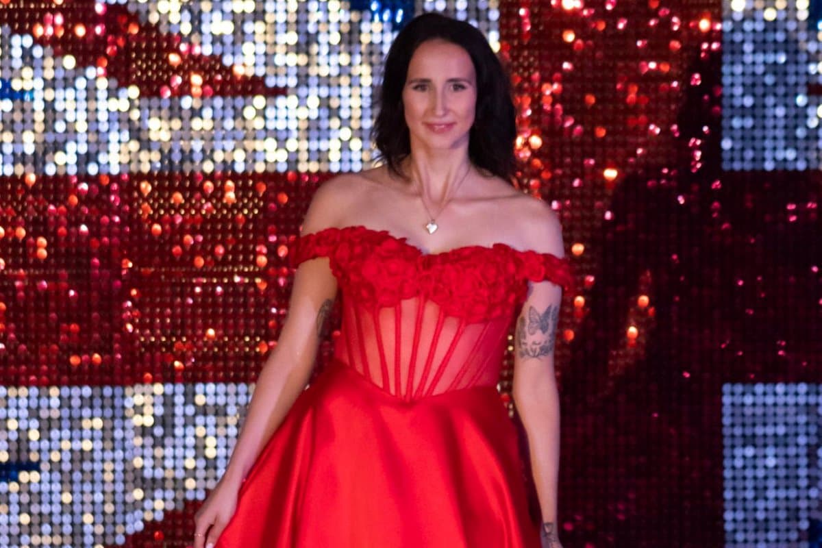 Emma in a red gown at a pageant event