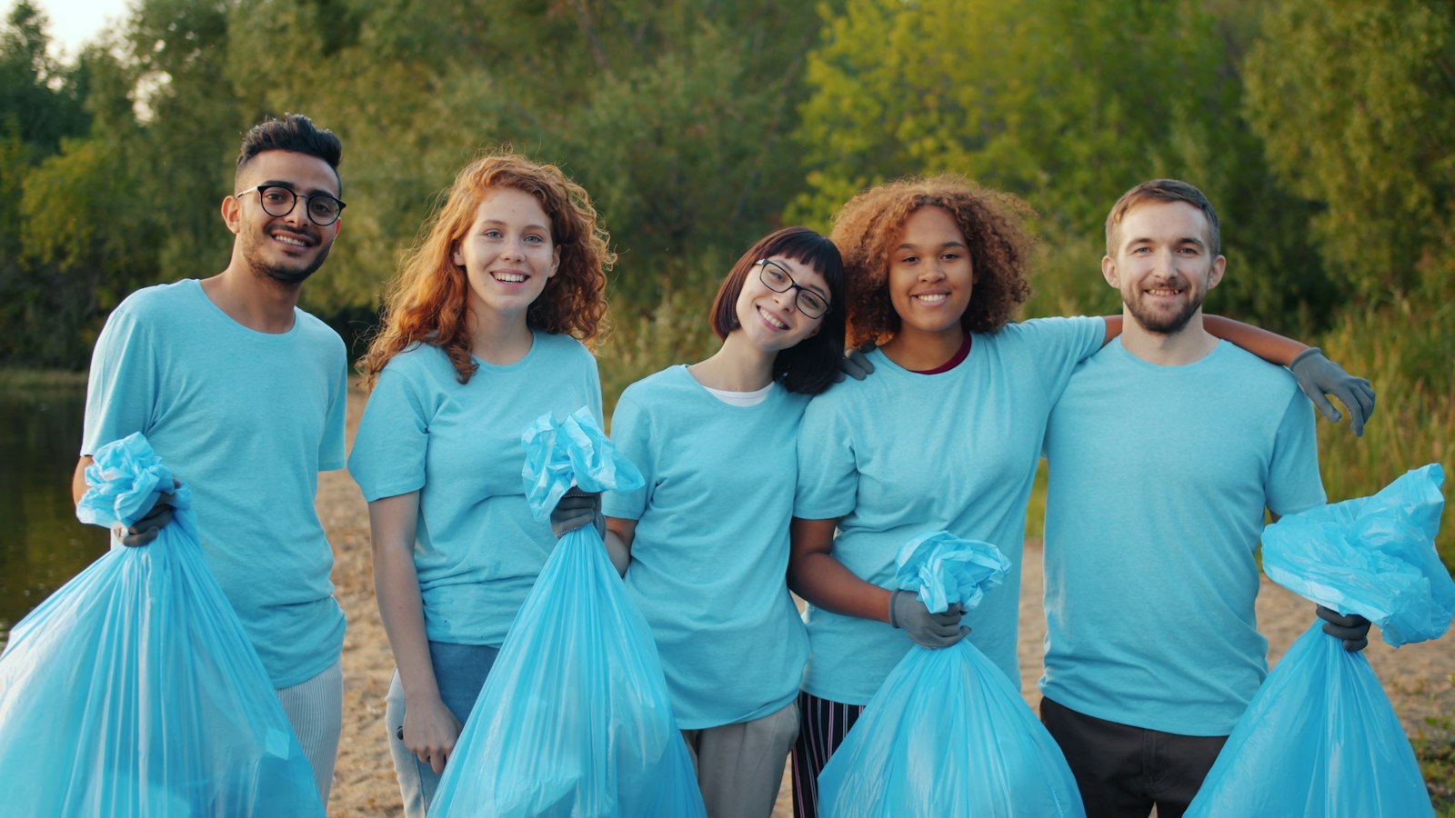 A group of smiling volunteers in matching T-shirts